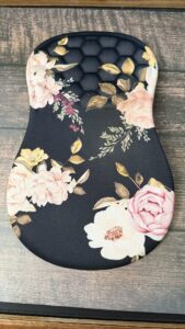 Ergonomic floral mouse pad, black with colorful flowers.